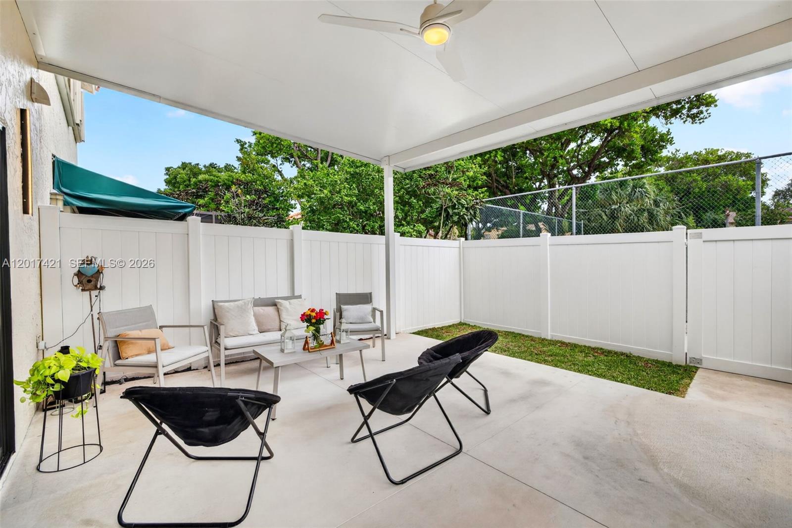 3848 Atlanta Street Hollywood, FL 33021 - Photo 3 of 79 Amazing covered patio w/ new PVC fence, backs up to the pool area (& tennis which is currently closed) for the community. Plenty of room for hot tub or large dining table