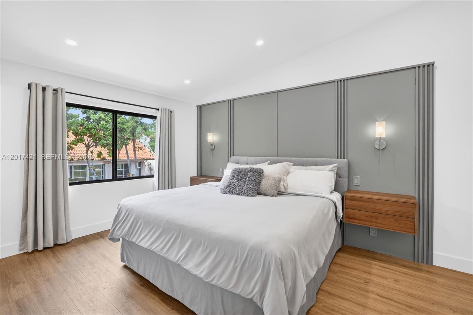 3848 Atlanta Street Hollywood, FL 33021 - Photo 35 of 79 Primary bedroom w/ attached nightstands, feature wall and reading sconces - overlooks front of property