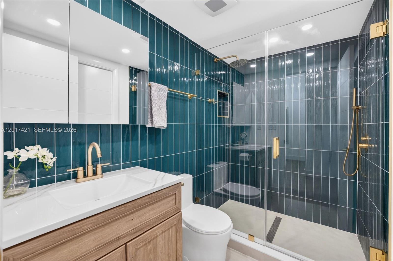 3848 Atlanta Street Hollywood, FL 33021 - Photo 5 of 79 Upgraded bathroom w/ gorgeous finishes, rain shower head & handheld, tile to the ceiling, frameless shower door & medicine cabinet