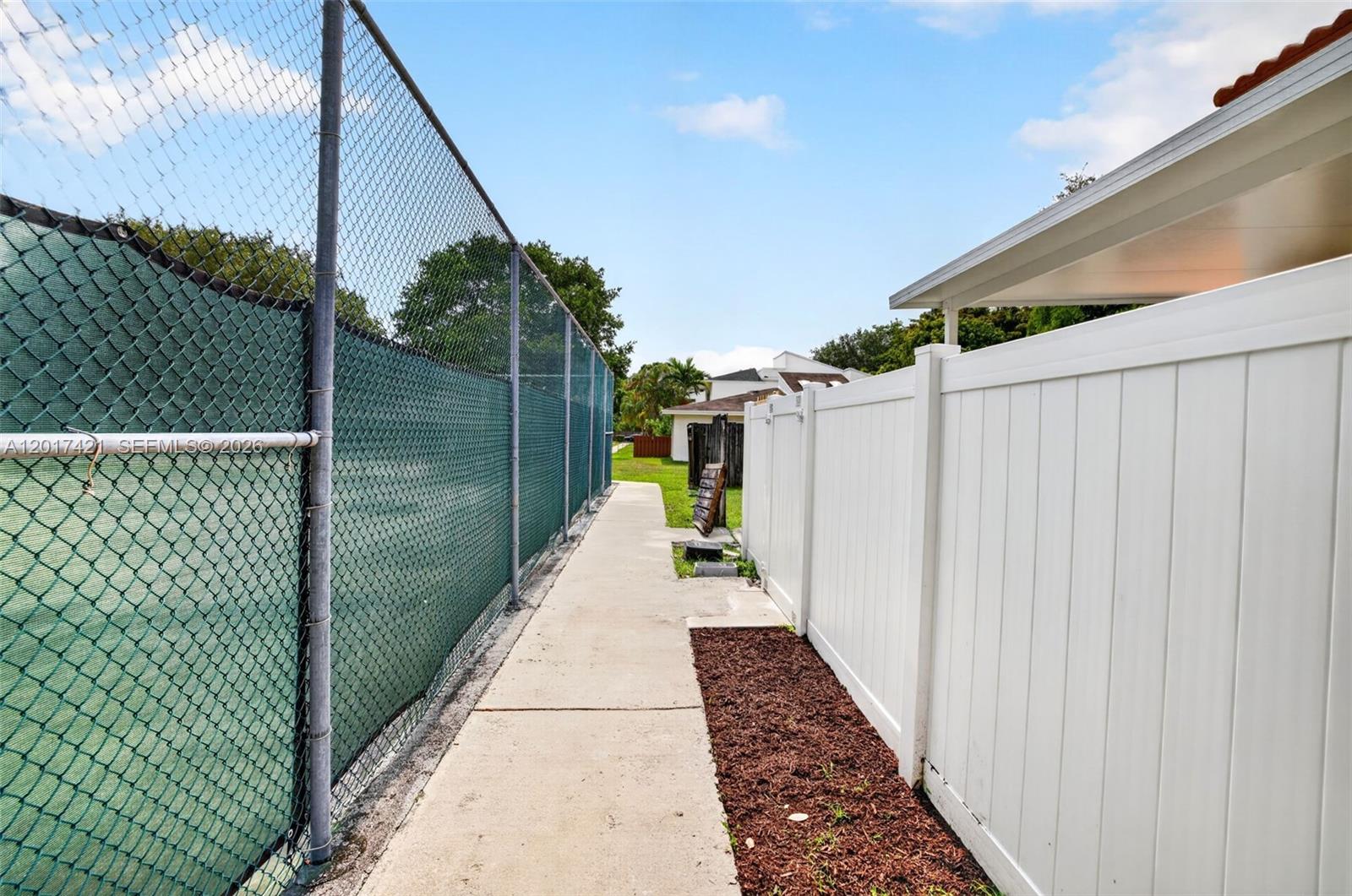 3848 Atlanta Street Hollywood, FL 33021 - Photo 58 of 79 Sidewalk between tennis and backyard fence