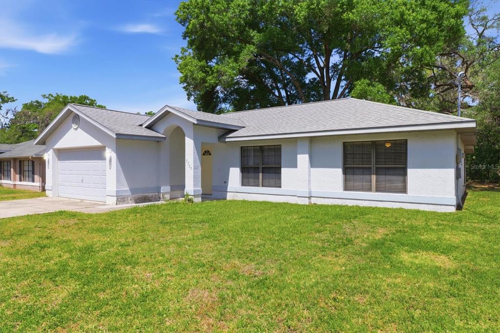 6355 East Rush Street Inverness, FL 34452 - Photo 3 of 27 a front view of a house with a garden