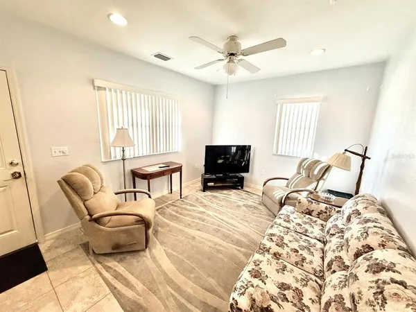 a bedroom with furniture and a flat screen tv