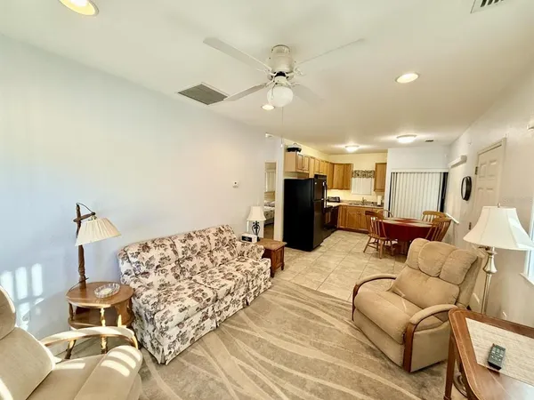 a living room with furniture a couch and a chandelier