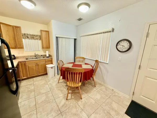 a view of a kitchen with a dining table and chairs