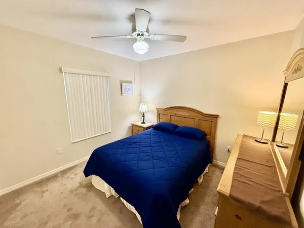 a bedroom with a bed and lamps