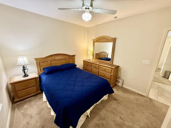 a bedroom with a bed and a chandelier