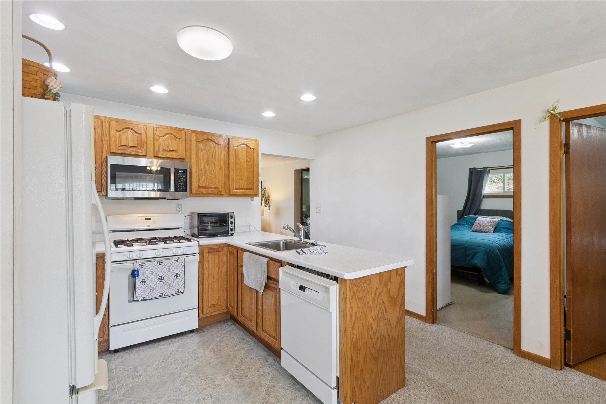 976 East Cedarville Road Freeport, IL 61032 - Photo 11 of 48 a kitchen with stainless steel appliances granite countertop a stove and a refrigerator