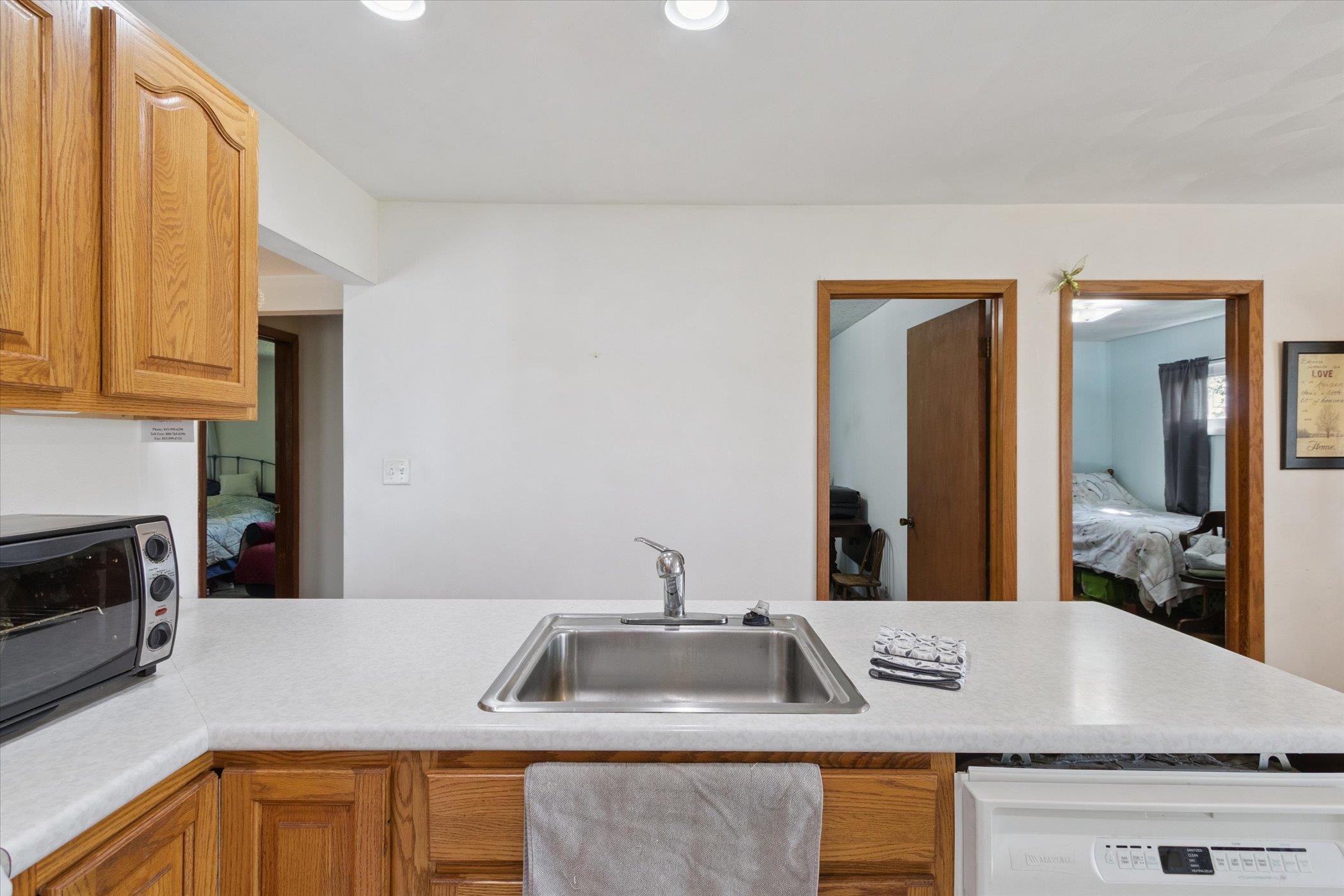 976 East Cedarville Road Freeport, IL 61032 - Photo 13 of 48 a kitchen with granite countertop a sink and a stove top oven