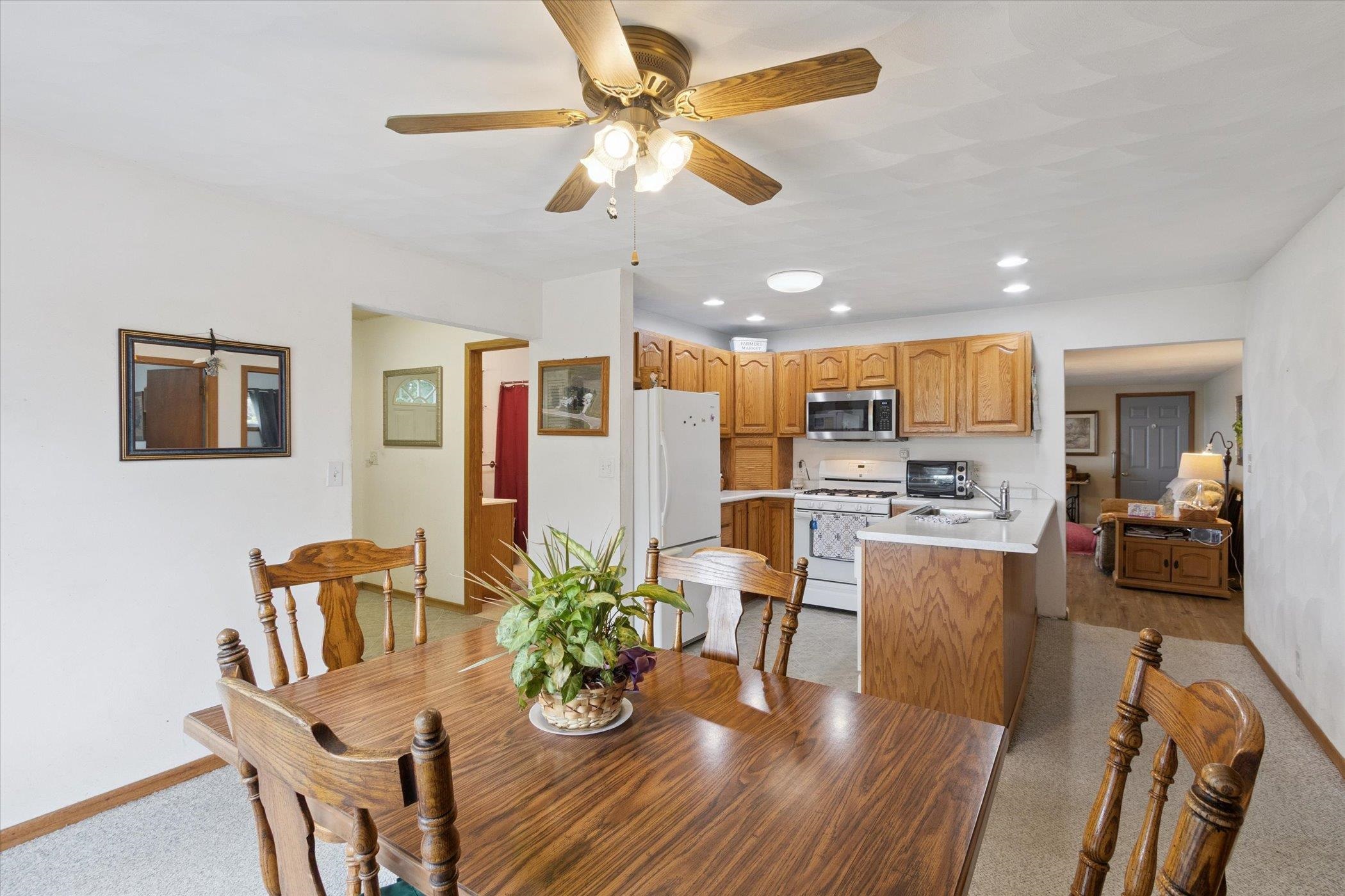976 East Cedarville Road Freeport, IL 61032 - Photo 18 of 48 a view of a dining room with furniture a kitchen and chandelier