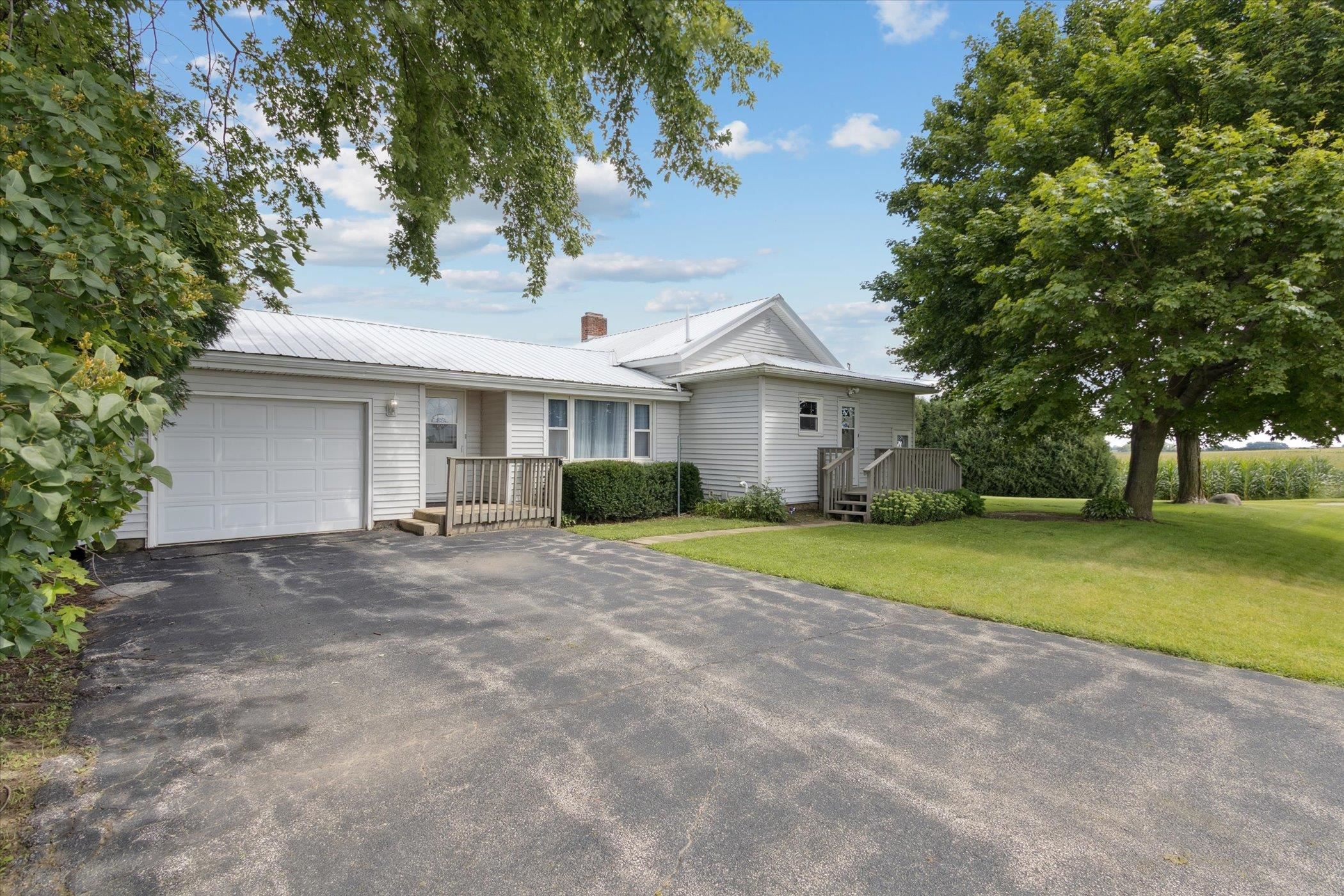 976 East Cedarville Road Freeport, IL 61032 - Photo 2 of 48 a front view of a house with a yard and garage
