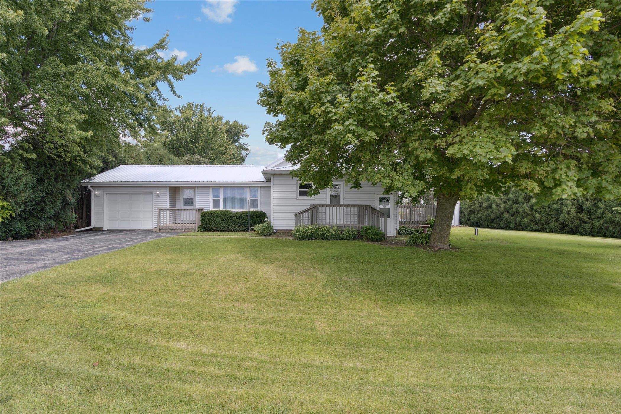 976 East Cedarville Road Freeport, IL 61032 - Photo 3 of 48 a front view of a house with a garden