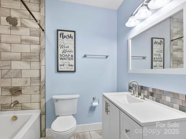 a view of hallway with closet and wooden floor