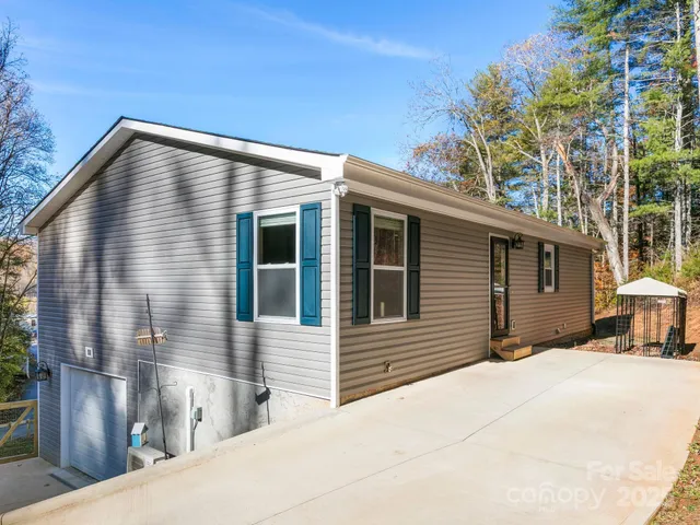 a open kitchen with stainless steel appliances granite countertop a stove top oven a sink and white cabinets