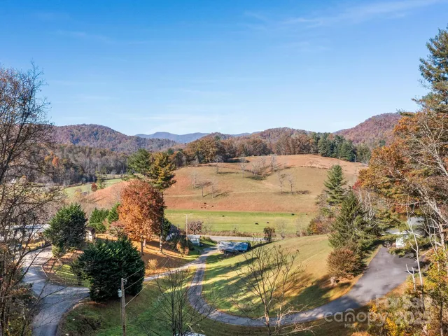 a view of a mountain with a yard