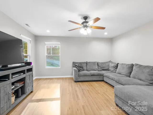 a living room with furniture and kitchen view