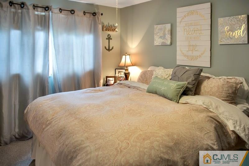 18 Chelsea Road Old Bridge, NJ 08857 - Photo 16 of 25 a bed sitting in a bedroom next to a window and a lamp