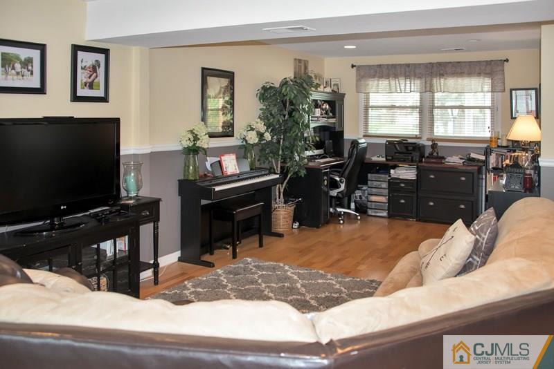 18 Chelsea Road Old Bridge, NJ 08857 - Photo 3 of 25 a living room with furniture and a flat screen tv