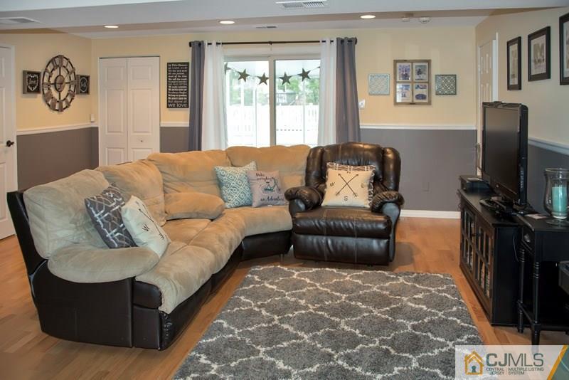 18 Chelsea Road Old Bridge, NJ 08857 - Photo 4 of 25 a living room with furniture and a flat screen tv