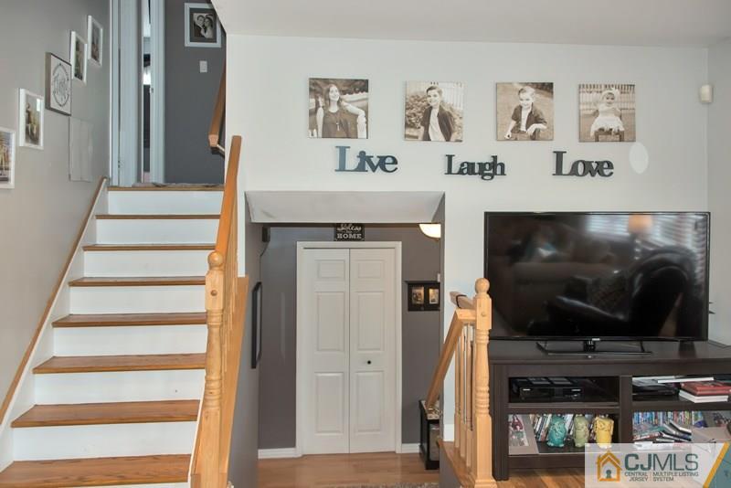 18 Chelsea Road Old Bridge, NJ 08857 - Photo 5 of 25 a living room with wooden floor and a flat screen tv