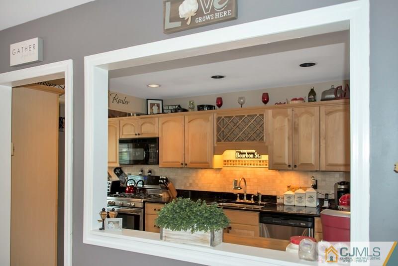 18 Chelsea Road Old Bridge, NJ 08857 - Photo 6 of 25 a kitchen with a stove and a microwave