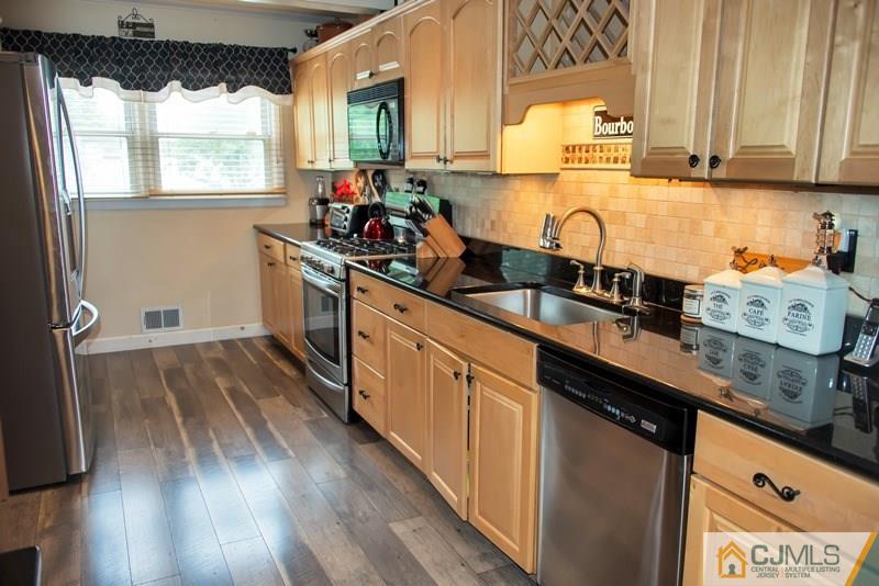 18 Chelsea Road Old Bridge, NJ 08857 - Photo 7 of 25 a kitchen with stainless steel appliances a sink window and cabinets