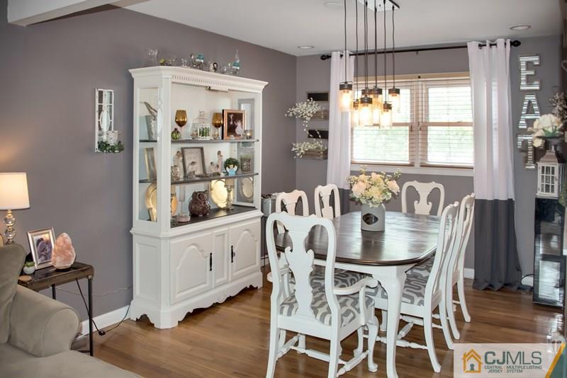 18 Chelsea Road Old Bridge, NJ 08857 - Photo 9 of 25 a dining room with furniture a chandelier and wooden floor