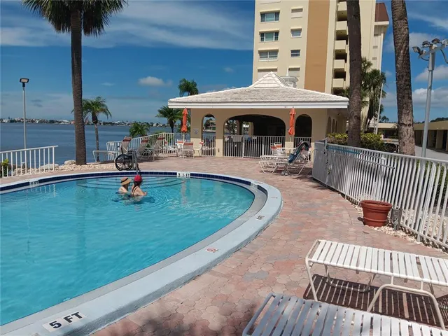 swimming pool view with a seating space