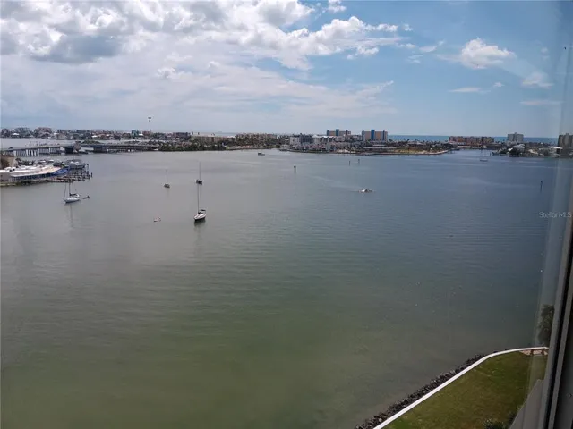 a view of a lake with houses in back