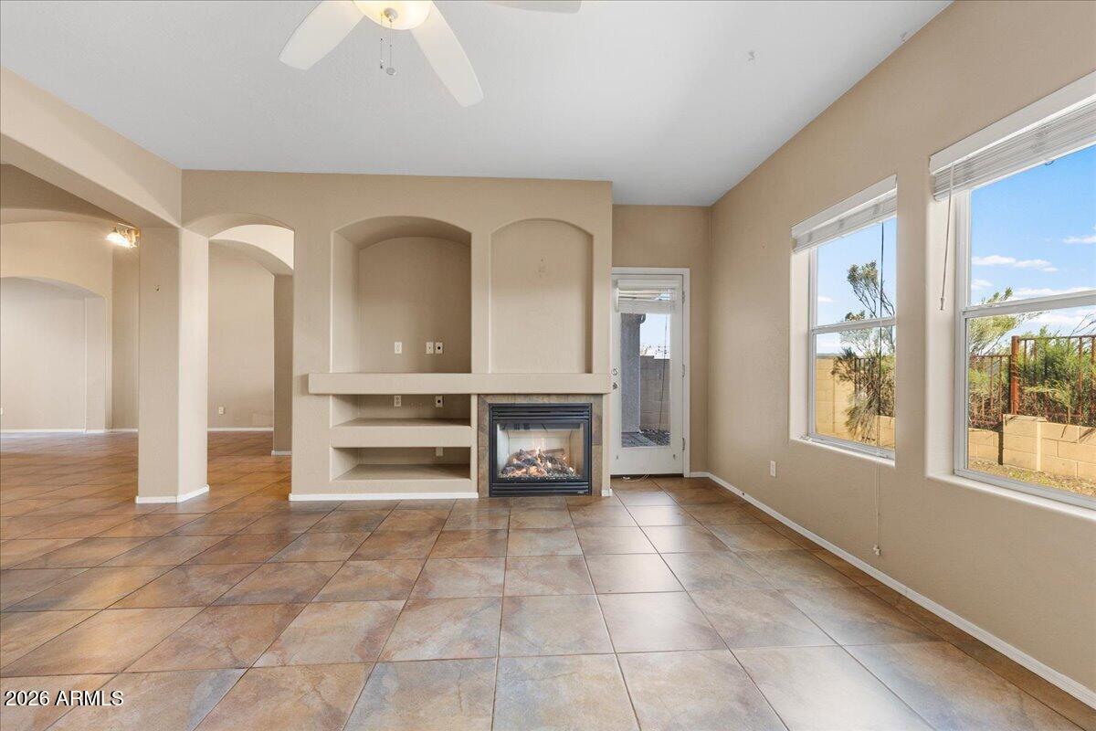 813 Alfonse Road Clarkdale, AZ 86324 - Photo 28 of 41 a view of an empty room with a fireplace and a large window