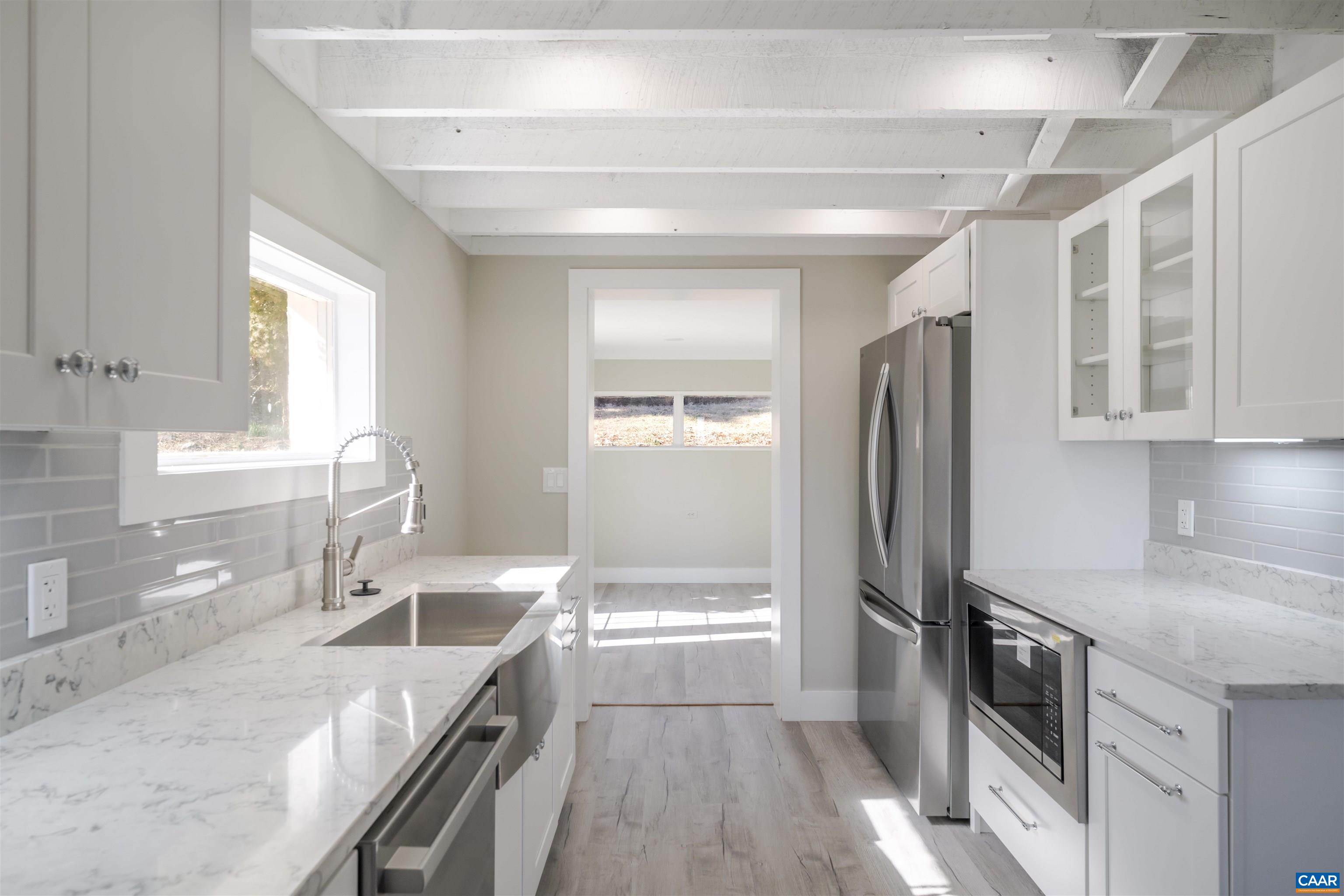 12413 Chicken Mountain Road Orange, VA 22960 - Photo 11 of 36 a kitchen with granite countertop a refrigerator and a sink