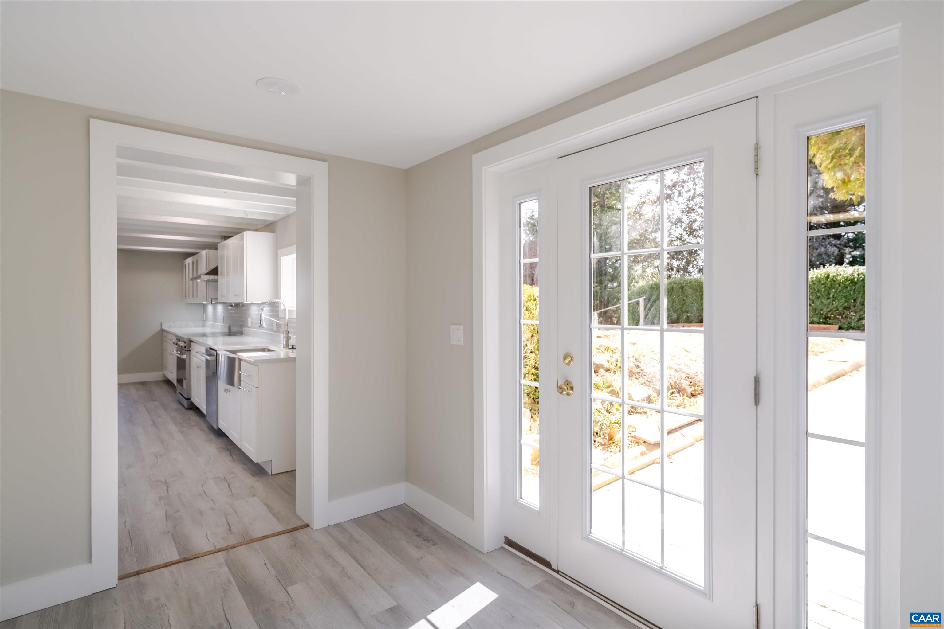 12413 Chicken Mountain Road Orange, VA 22960 - Photo 13 of 36 a view of a hallway with wooden floor and a living room