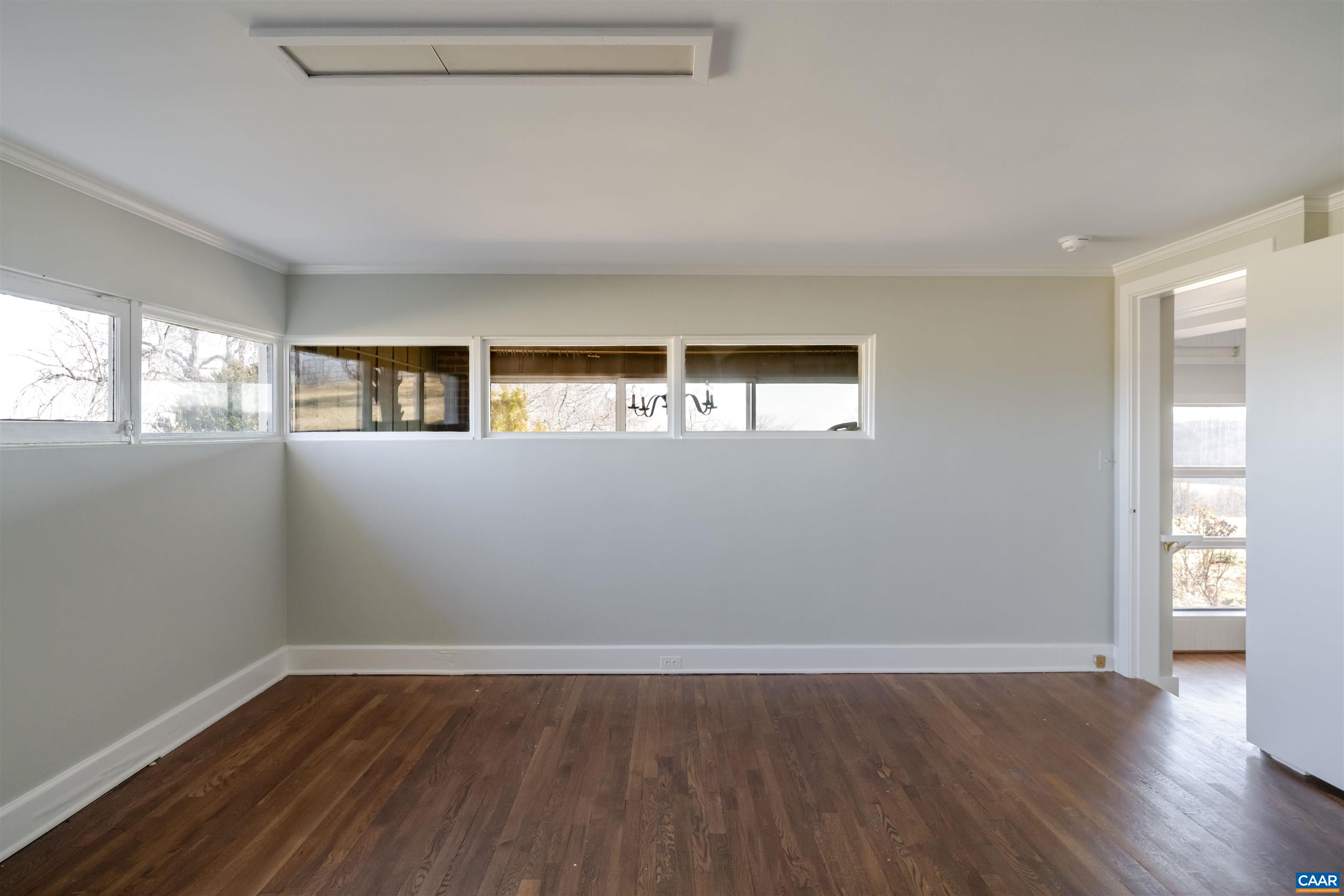 12413 Chicken Mountain Road Orange, VA 22960 - Photo 19 of 36 an empty room with wooden floor and windows