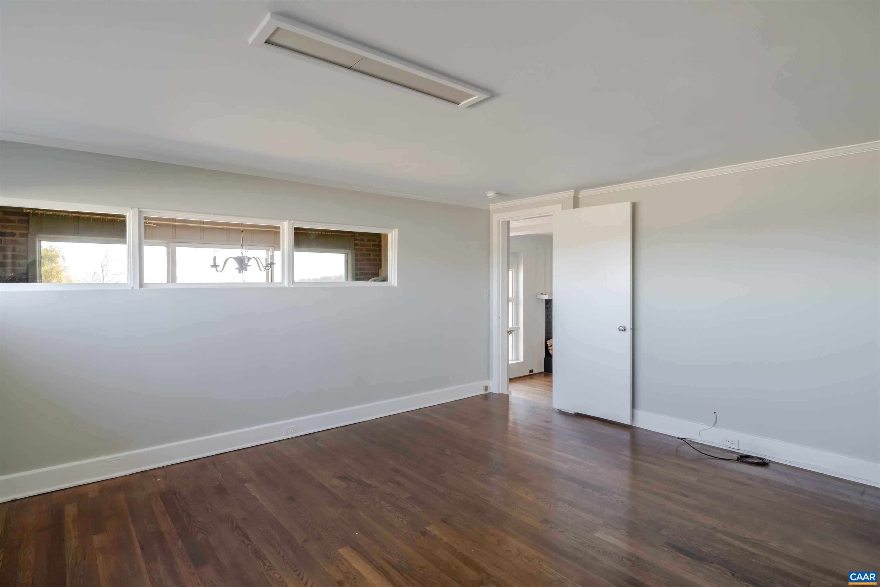 12413 Chicken Mountain Road Orange, VA 22960 - Photo 20 of 36 a view of an empty room with wooden floor and a window