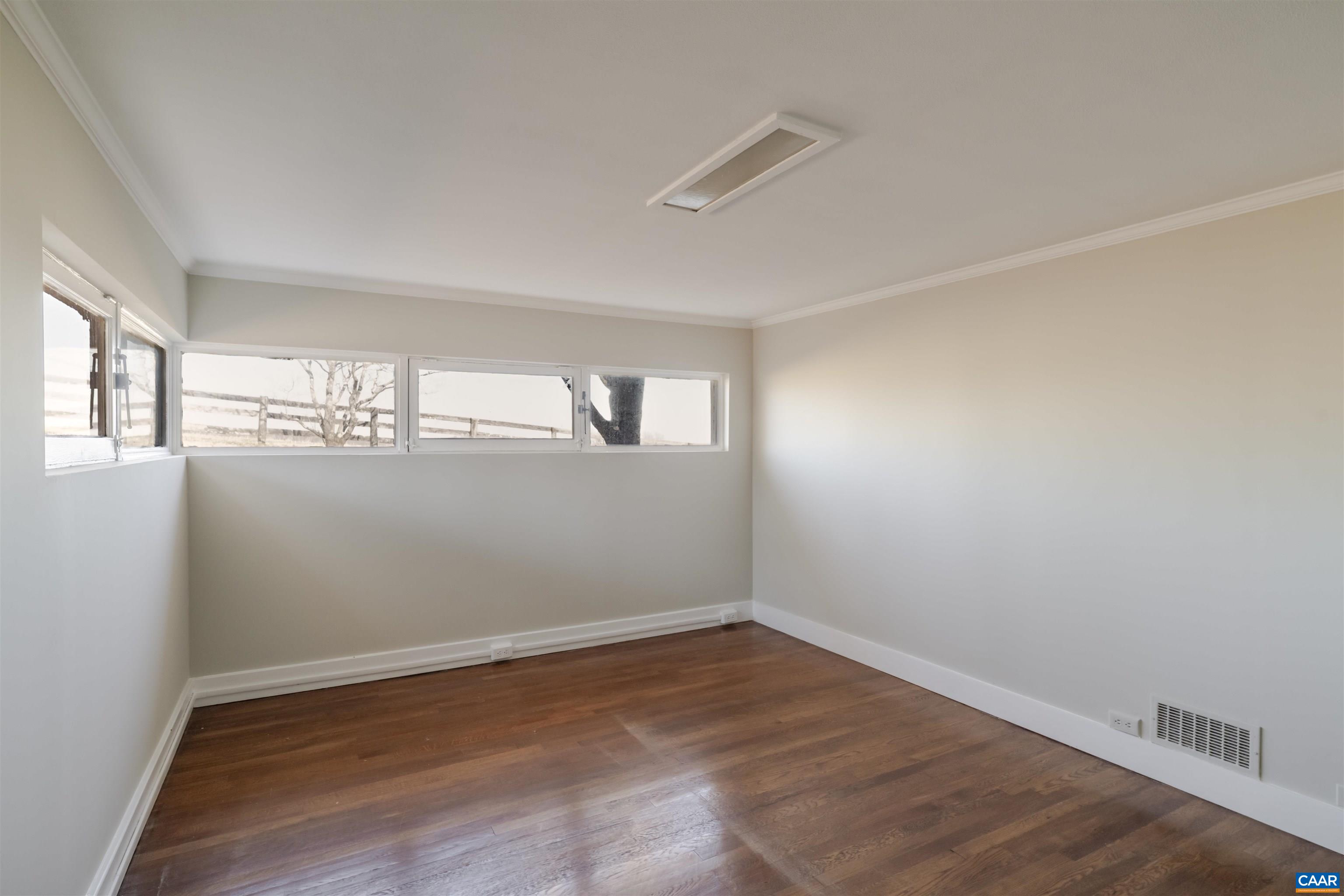12413 Chicken Mountain Road Orange, VA 22960 - Photo 24 of 36 an empty room with wooden floor and windows