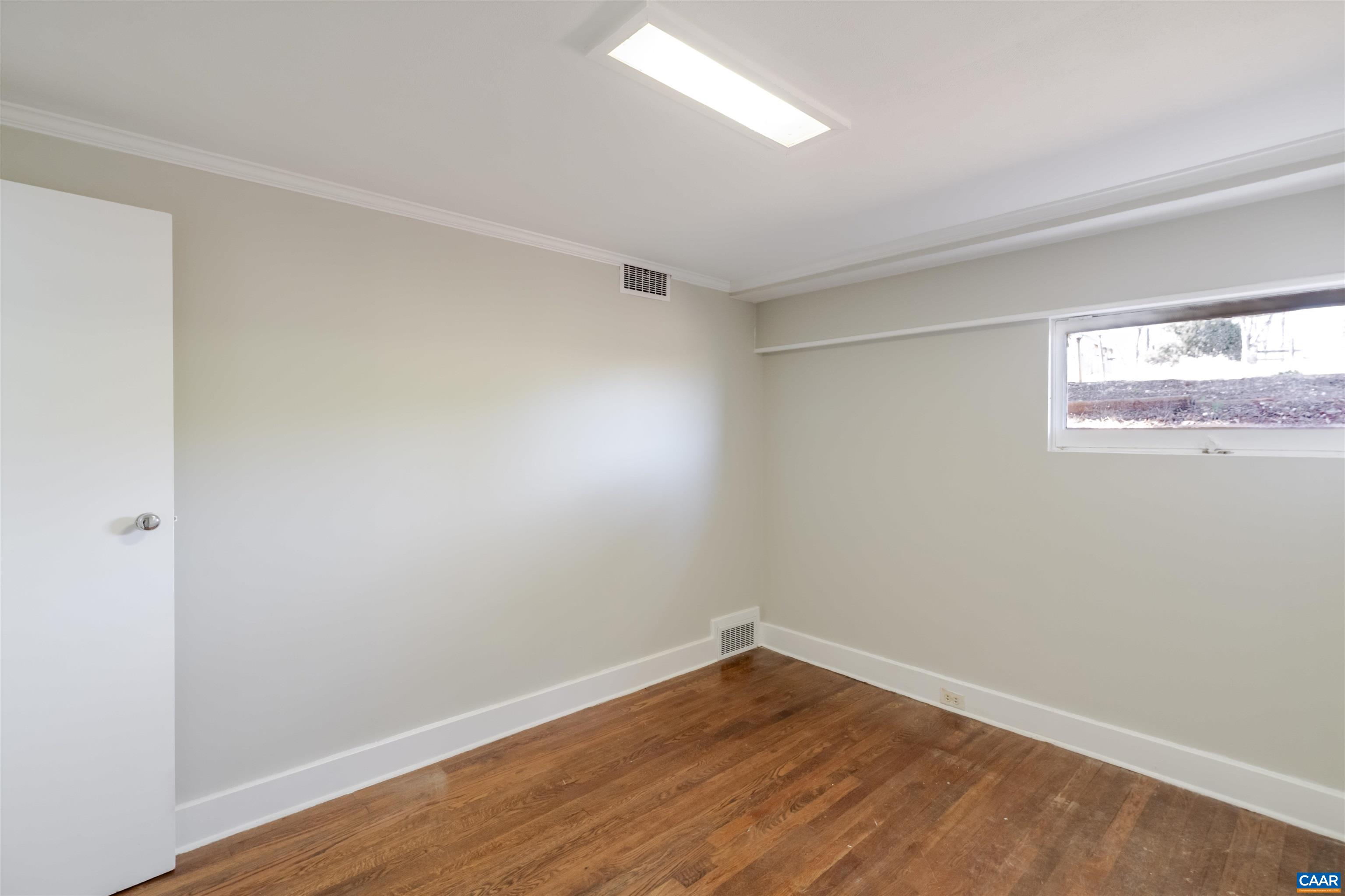 12413 Chicken Mountain Road Orange, VA 22960 - Photo 27 of 36 a view of an empty room with wooden floor and a window
