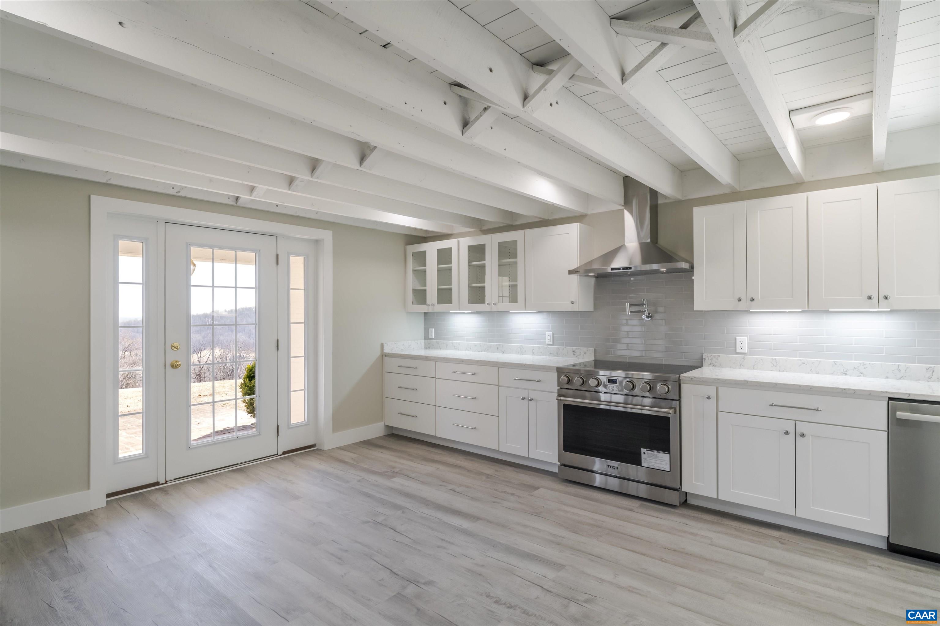 12413 Chicken Mountain Road Orange, VA 22960 - Photo 8 of 36 a large kitchen with stainless steel appliances granite countertop a stove and a refrigerator