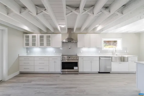 a kitchen with stainless steel appliances granite countertop a stove and cabinets
