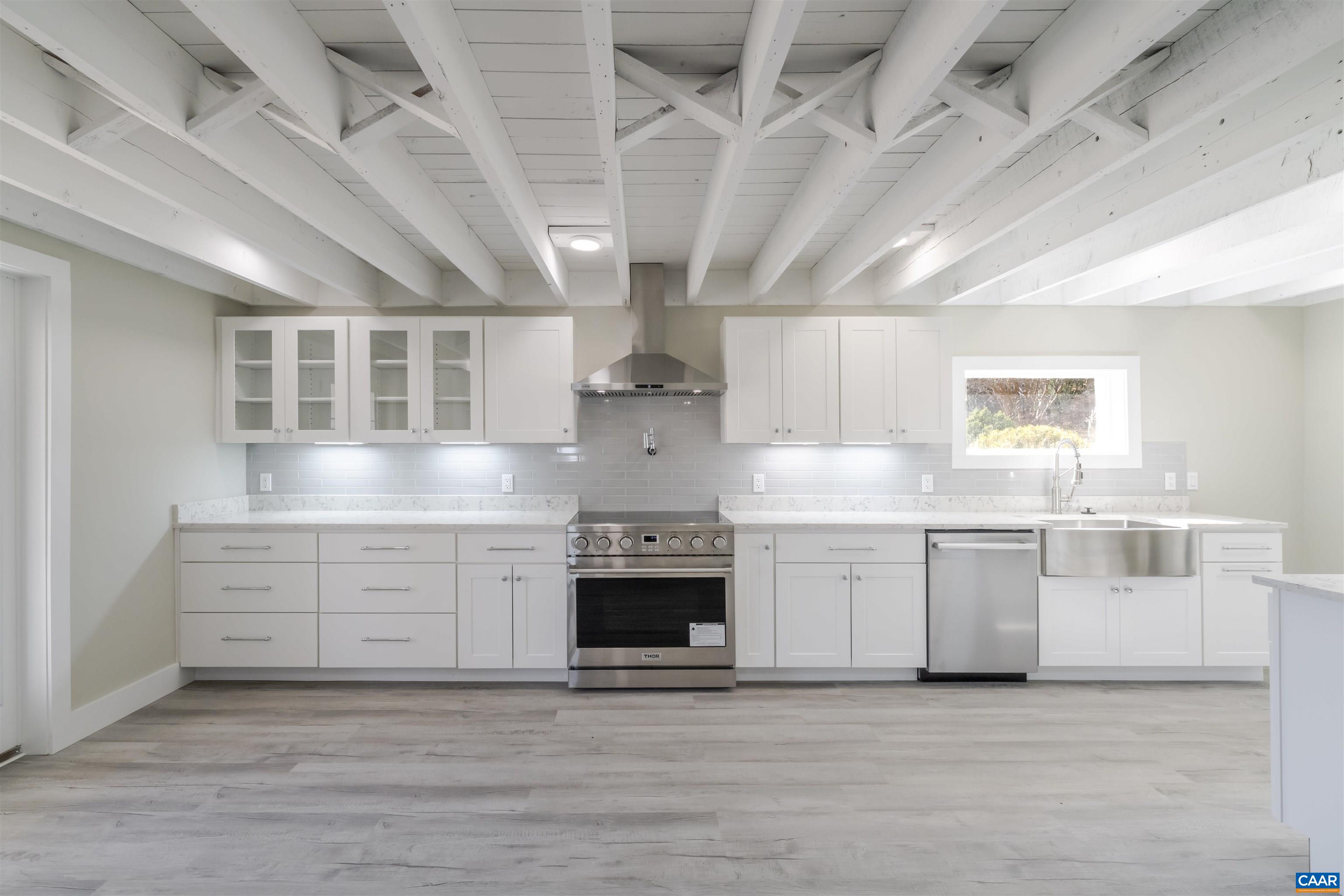 12413 Chicken Mountain Road Orange, VA 22960 - Photo 9 of 36 a kitchen with stainless steel appliances granite countertop a stove and cabinets