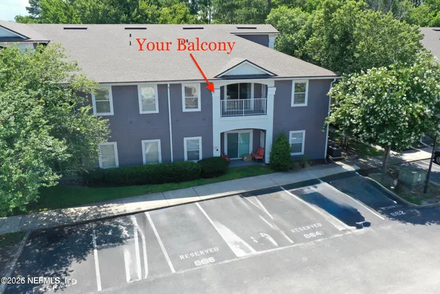 a view of a white house with a yard