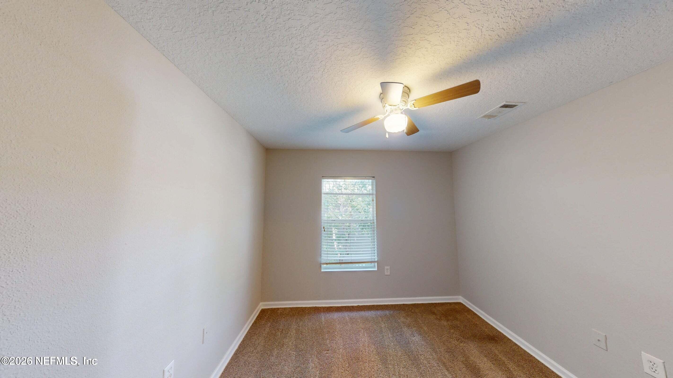 7920 Merrill Road, Unit 1509 Jacksonville, FL 32277 - Photo 8 of 11 a view of a room with a window and a ceiling fan
