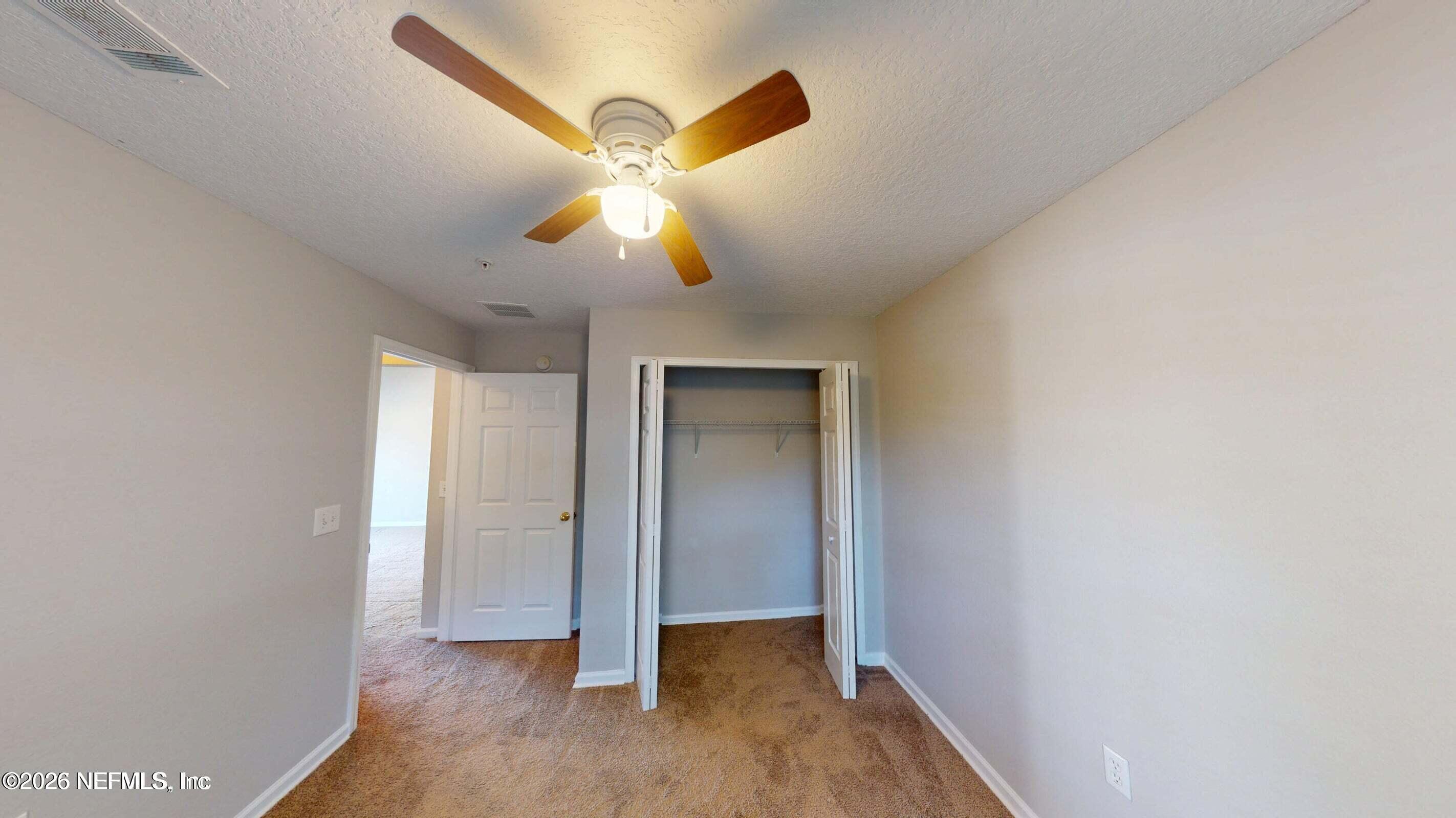 7920 Merrill Road, Unit 1509 Jacksonville, FL 32277 - Photo 9 of 11 a view of an empty room with a window