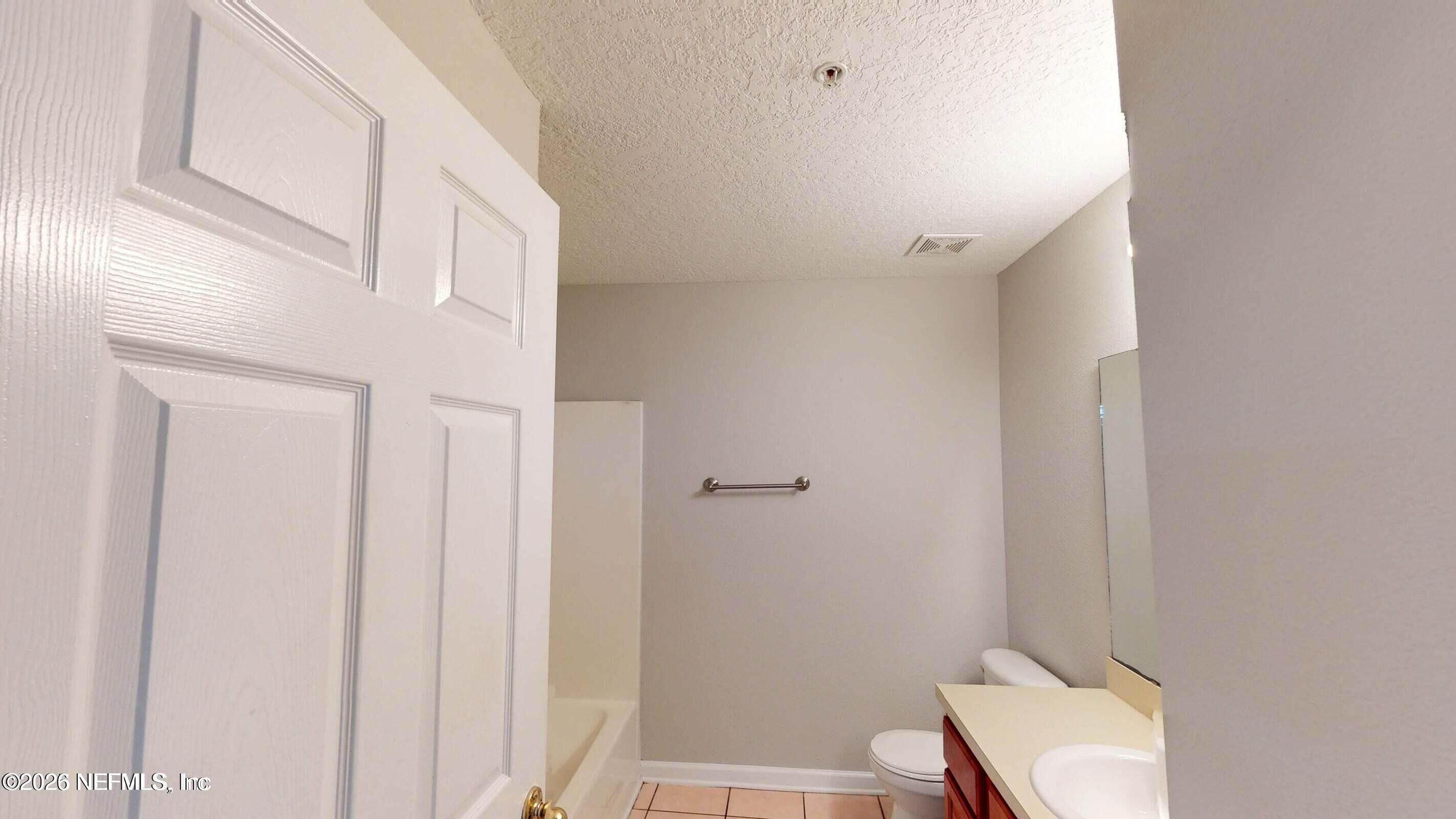 7920 Merrill Road, Unit 1509 Jacksonville, FL 32277 - Photo 10 of 11 a bathroom with a sink and a mirror