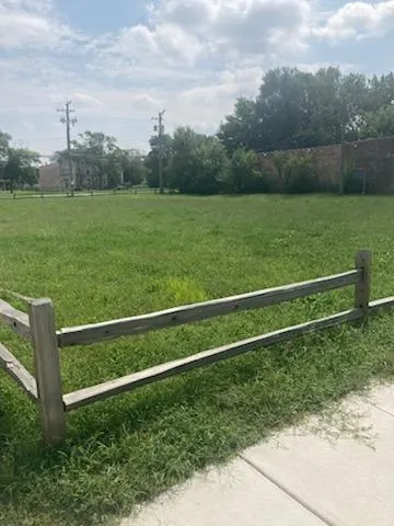 a view of field with grass and a fence