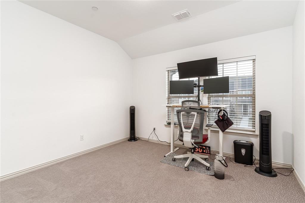 7368 Panicum Drive Frisco, TX 75033 - Photo 17 of 25 Exercise area with carpet flooring and vaulted ceiling