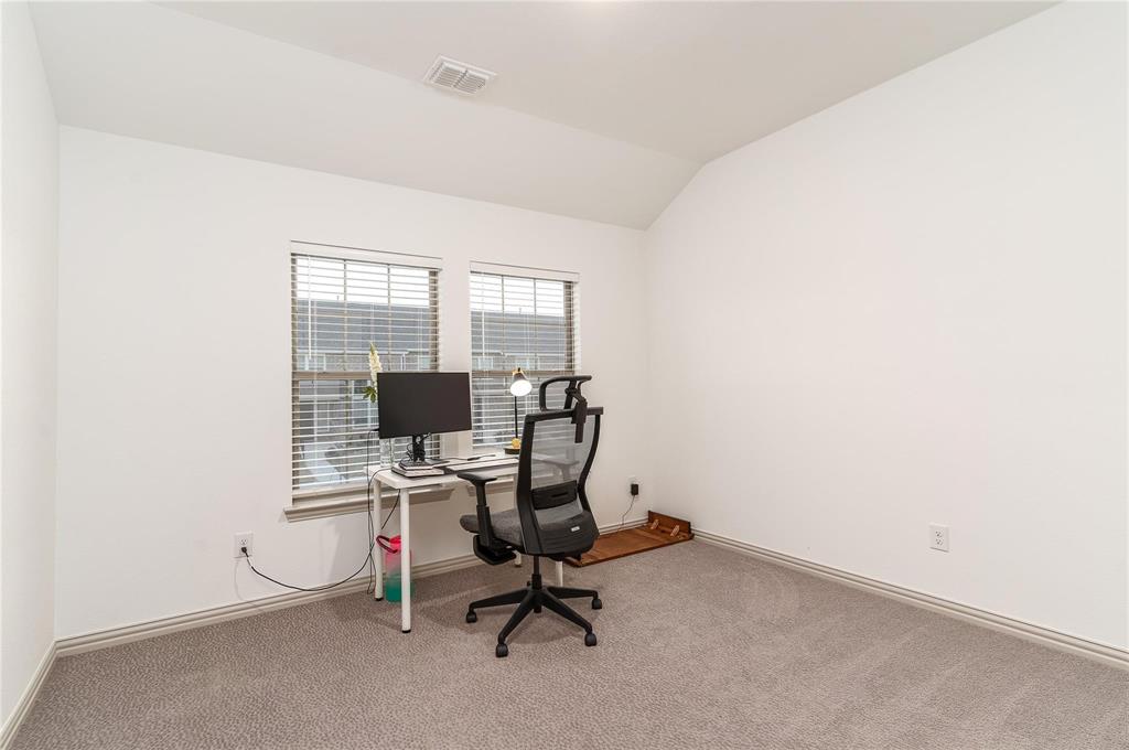 7368 Panicum Drive Frisco, TX 75033 - Photo 18 of 25 Office with carpet flooring and lofted ceiling