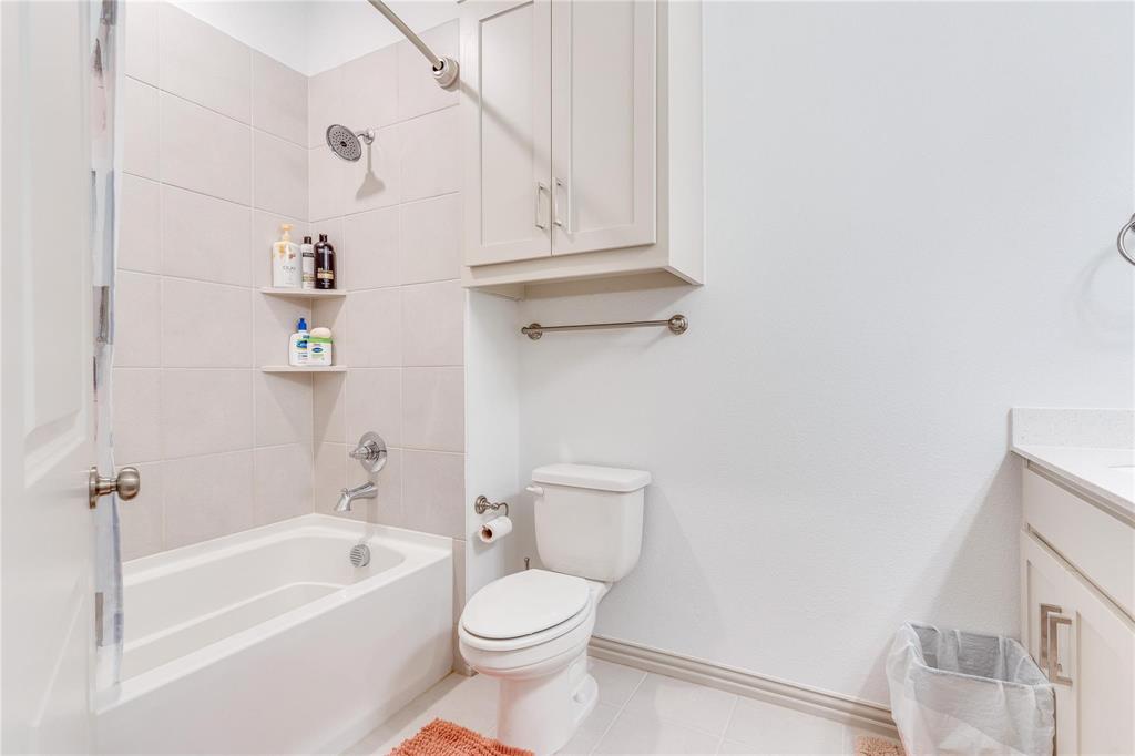 7368 Panicum Drive Frisco, TX 75033 - Photo 20 of 25 Full bathroom featuring tile patterned floors, toilet, vanity, and tiled shower / bath
