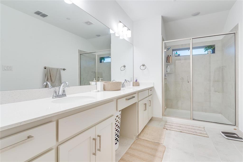 7368 Panicum Drive Frisco, TX 75033 - Photo 23 of 25 Bathroom with tile patterned flooring, vanity, and a shower with shower door