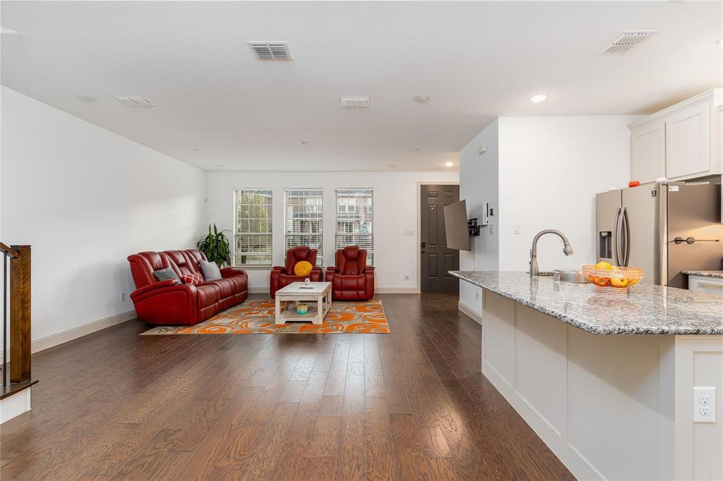 7368 Panicum Drive Frisco, TX 75033 - Photo 5 of 25 Living room with dark wood-type flooring and sink