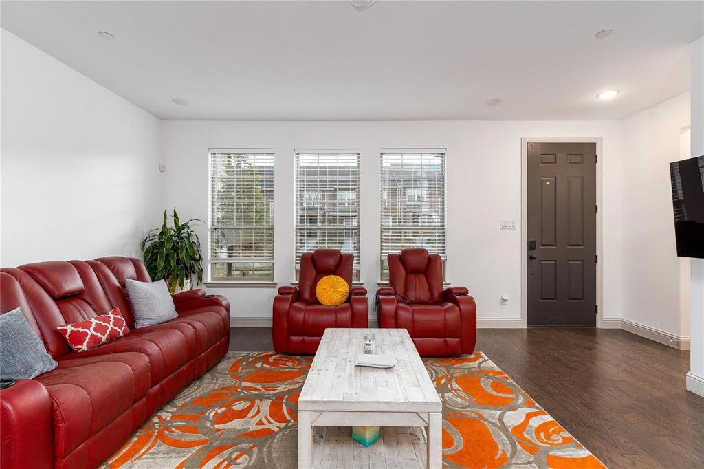 7368 Panicum Drive Frisco, TX 75033 - Photo 7 of 25 Living room featuring dark hardwood / wood-style floors and a wealth of natural light