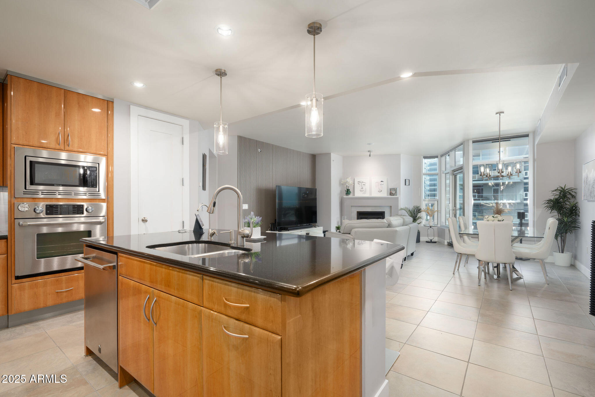 a kitchen with stainless steel appliances granite countertop a sink stove and cabinets
